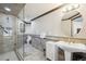 Bathroom with a large glass shower, tiled walls, and neutral vanity at 7081 Salvia St, Arvada, CO 80007