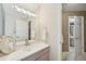 Bright bathroom featuring tiled floors, a large mirror, and vanity at 7081 Salvia St, Arvada, CO 80007