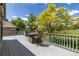 Outdoor deck with seating and view of the backyard landscape and blue sky at 7081 Salvia St, Arvada, CO 80007