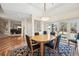 Bright dining room featuring wood table/chairs, area rug, patio access, and views into the living room at 7081 Salvia St, Arvada, CO 80007