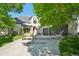 Inviting home featuring a manicured lawn, mature trees, and an attached two car garage at 7081 Salvia St, Arvada, CO 80007