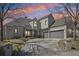 Charming home featuring a curved driveway, well-maintained landscaping, and a three-car garage at 7081 Salvia St, Arvada, CO 80007