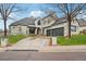 Stunning home featuring meticulous landscaping, a porte-cochere, an attached garage, and a wide driveway at 7081 Salvia St, Arvada, CO 80007