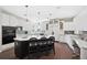 Modern kitchen with a large island, black appliances, and open layout perfect for entertaining at 7081 Salvia St, Arvada, CO 80007