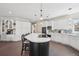 Bright and spacious kitchen with a large island, cooktop, and abundant storage at 7081 Salvia St, Arvada, CO 80007