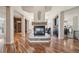 Inviting living room with a stone fireplace, gleaming hardwood floors, and abundant natural light at 7081 Salvia St, Arvada, CO 80007