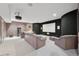 A home theater room with comfortable seating, projector, and a large screen for immersive entertainment at 7081 Salvia St, Arvada, CO 80007