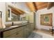Well-lit bathroom boasting double sinks, modern fixtures, and a large vanity mirror at 80 Spruce Ct, Evergreen, CO 80439