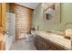 Charming bathroom features marble countertops and wood-paneled wall at 80 Spruce Ct, Evergreen, CO 80439