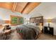 Cozy bedroom with wood accents, view to the backyard, and warm natural light at 80 Spruce Ct, Evergreen, CO 80439