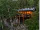 Log cabin showcases solar panels and an outdoor deck with amazing views of the surrounding nature at 80 Spruce Ct, Evergreen, CO 80439