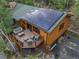Exterior of the log cabin features solar panels, an outdoor deck, and a two-car garage at 80 Spruce Ct, Evergreen, CO 80439