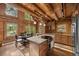 Open concept kitchen with a cooktop island, stainless appliances, and hardwood floors at 80 Spruce Ct, Evergreen, CO 80439