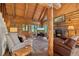 Warm living room with stone fireplace, vaulted ceilings, and rustic wood beams at 80 Spruce Ct, Evergreen, CO 80439