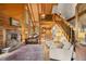 Comfortable living room boasts a stone fireplace and exposed wood beam vaulted ceilings at 80 Spruce Ct, Evergreen, CO 80439