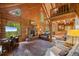 Cozy living room featuring a stone fireplace, hardwood floors, and vaulted ceilings at 80 Spruce Ct, Evergreen, CO 80439