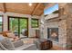 Inviting living room with stone fireplace and outdoor access at 80 Spruce Ct, Evergreen, CO 80439