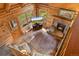 Comfortable living room with fireplace, wood-paneled walls, and view of the outdoors at 80 Spruce Ct, Evergreen, CO 80439