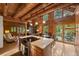 Open concept living space with a kitchen island and access to outdoor patio at 80 Spruce Ct, Evergreen, CO 80439