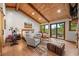 Spacious main bedroom boasts wood floors, vaulted ceiling, and outdoor access at 80 Spruce Ct, Evergreen, CO 80439