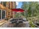 Outdoor patio with dining table, umbrella, and mountain views, perfect for enjoying nature at 80 Spruce Ct, Evergreen, CO 80439