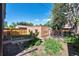 Backyard with green grass, brick building, stone path, and wooden fence at 766 Monroe St, Denver, CO 80206