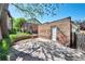 Backyard with stone tiles, a brick building, and flourishing green plants at 766 Monroe St, Denver, CO 80206