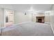 Unfinished basement area with a brick fireplace and painted concrete floor at 766 Monroe St, Denver, CO 80206
