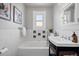 Bright bathroom featuring a tub with classic white tile and artistic green accents at 766 Monroe St, Denver, CO 80206