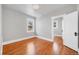 Clean bedroom with hardwood flooring and a connecting door to an additional room at 766 Monroe St, Denver, CO 80206