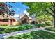 Charming home exterior with lush lawn, stone walkway, and mature tree at 766 Monroe St, Denver, CO 80206