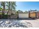 Exterior shot of garage and driveway with fence and trees at 766 Monroe St, Denver, CO 80206