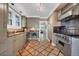 Updated kitchen featuring stainless steel appliances, designer flooring and seamless flow into dining room at 766 Monroe St, Denver, CO 80206
