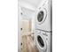 Stacked washer and dryer in a dedicated space near a bathroom with tiled shower and tub at 4899 S Dudley St # 7E, Littleton, CO 80123