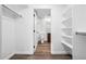Walk-in closet leads to bathroom and shelves, offering ample storage and organization solutions at 4899 S Dudley St # 7E, Littleton, CO 80123