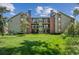Exterior view of the property with green space and mature trees at 4899 S Dudley St # 7E, Littleton, CO 80123