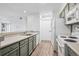 View of bright kitchen from living room with updated appliances at 4899 S Dudley St # 7E, Littleton, CO 80123