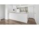 Bright kitchen features a breakfast bar and a washing machine at 4899 S Dudley St # 7E, Littleton, CO 80123