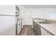 Bright kitchen featuring updated appliances, gray cabinetry, and ample counter space at 4899 S Dudley St # 7E, Littleton, CO 80123