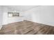 Spacious living room with wood-look floors leading to a kitchen with ample countertop space at 4899 S Dudley St # 7E, Littleton, CO 80123