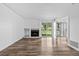 Bright living room features wood-look floors, a fireplace, and sliding glass doors for natural light at 4899 S Dudley St # 7E, Littleton, CO 80123
