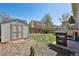 Fenced backyard with a storage shed and a grill at 9655 W 105Th Way, Broomfield, CO 80021