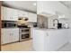 Modern kitchen features white cabinets, stainless appliances, and granite countertops at 9655 W 105Th Way, Broomfield, CO 80021