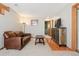 Spacious living room with wood floors, a leather sofa, and a modern entertainment center at 9655 W 105Th Way, Broomfield, CO 80021