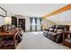 Bright living room featuring plush sofas, an exposed beam, and large windows at 9655 W 105Th Way, Broomfield, CO 80021