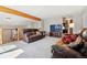 Inviting living area with plush seating, a beamed ceiling, and an open layout at 9655 W 105Th Way, Broomfield, CO 80021