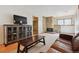 Cozy living room with a stone fireplace, comfortable leather sofa, and TV at 9655 W 105Th Way, Broomfield, CO 80021