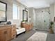 Modern bathroom with double vanities, decorative mirrors, and a stylish walk-in shower at 5726 Margarita Pt, Parker, CO 80134