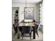 Elegant dining area with stylish chairs, modern lighting, and a large window for natural light at 5726 Margarita Pt, Parker, CO 80134