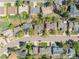 Aerial view of a home surrounded by mature trees, showcasing its location within a residential neighborhood at 128 Baylor Dr, Longmont, CO 80503